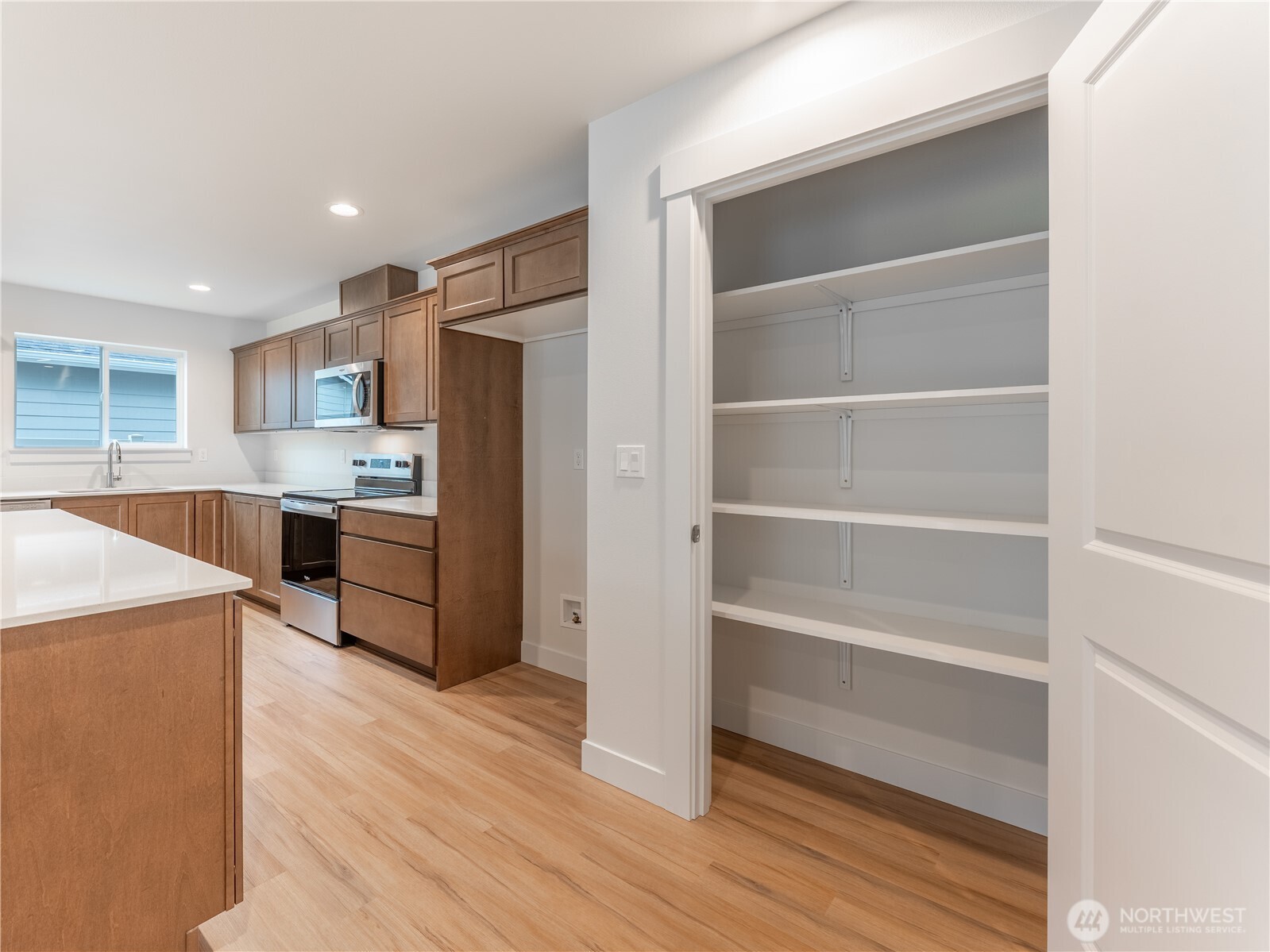 104 Salmon Drive Wenatchee, WA 98801 - Photo 12 of 35 a kitchen with a refrigerator a stove and a cabinets
