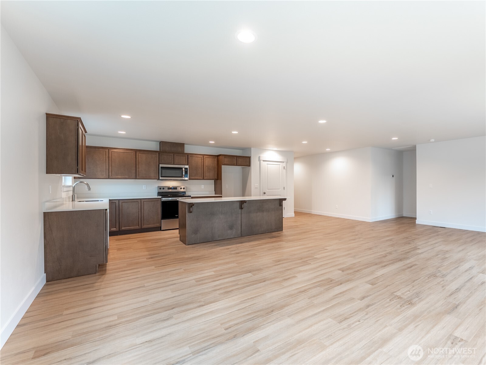 104 Salmon Drive Wenatchee, WA 98801 - Photo 14 of 35 a large kitchen with stainless steel appliances kitchen island a large counter top and a wooden floors