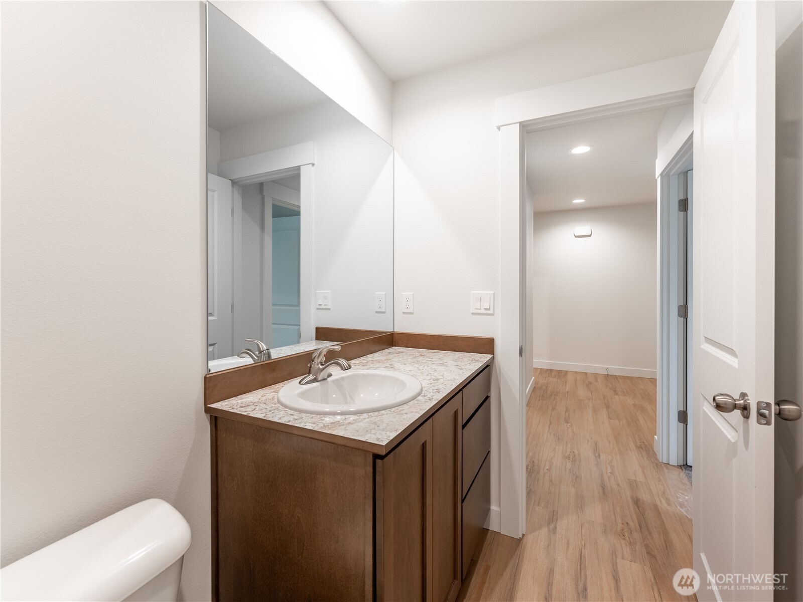 104 Salmon Drive Wenatchee, WA 98801 - Photo 29 of 35 a bathroom with a granite countertop sink a toilet and a mirror