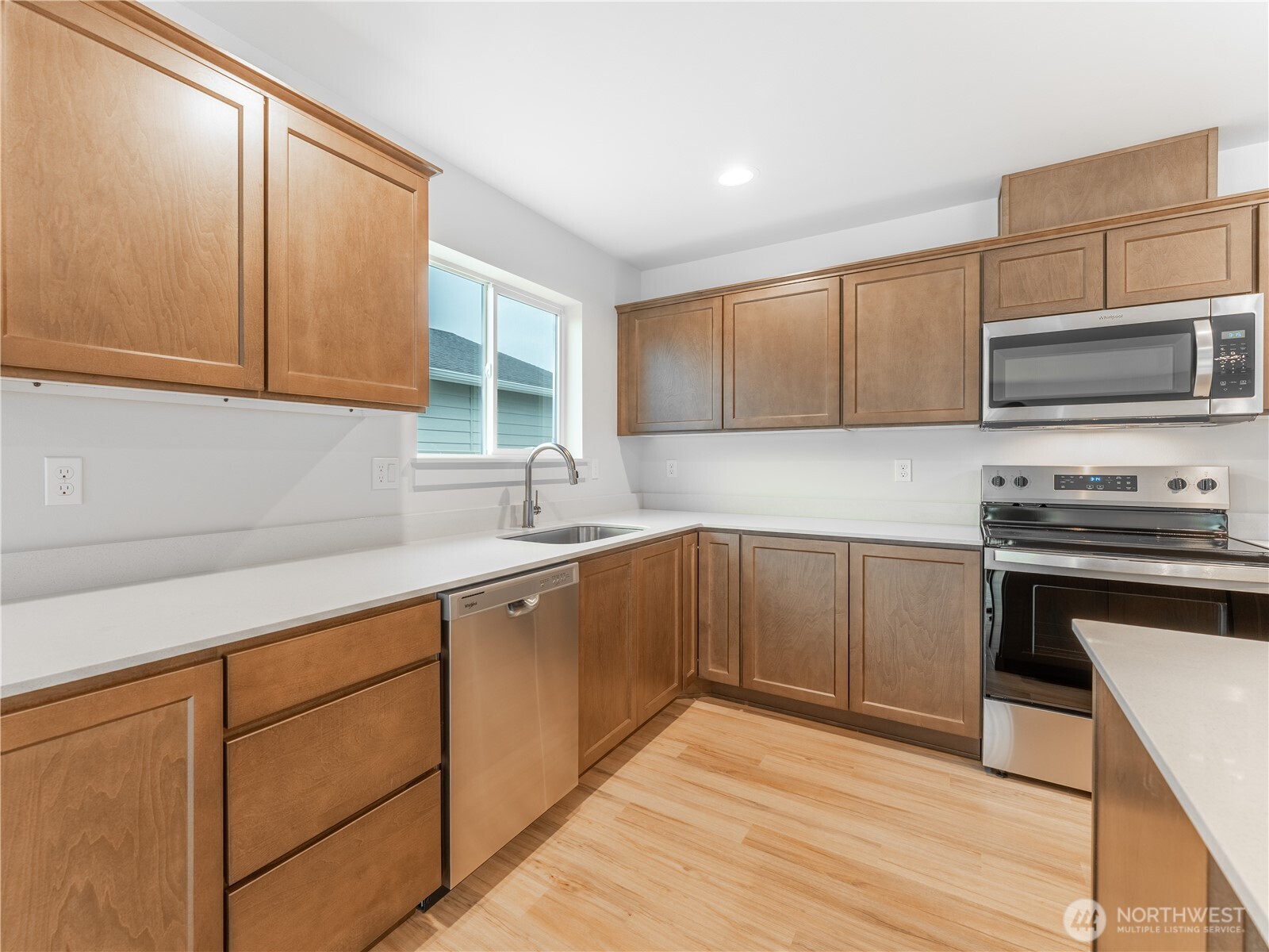 104 Salmon Drive Wenatchee, WA 98801 - Photo 9 of 35 a kitchen with cabinets stainless steel appliances and a sink