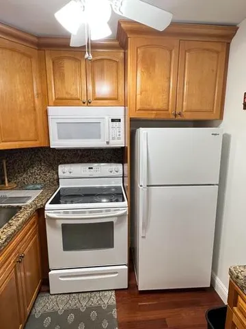 a stove top oven sitting inside of a kitchen