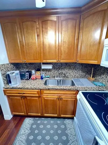 a kitchen with stainless steel appliances granite countertop a sink and cabinets