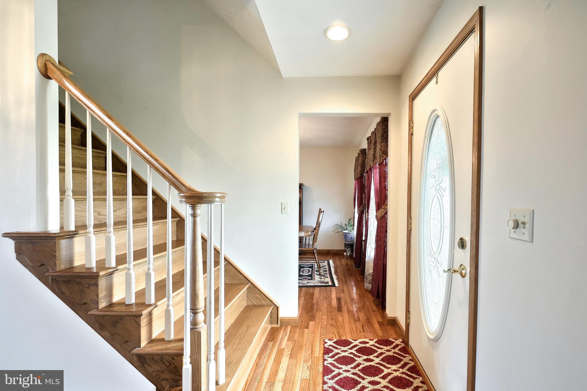 574 Mathias Road Littlestown, PA 17340 - Photo 15 of 65 a view of a hallway with wooden floor and staircase