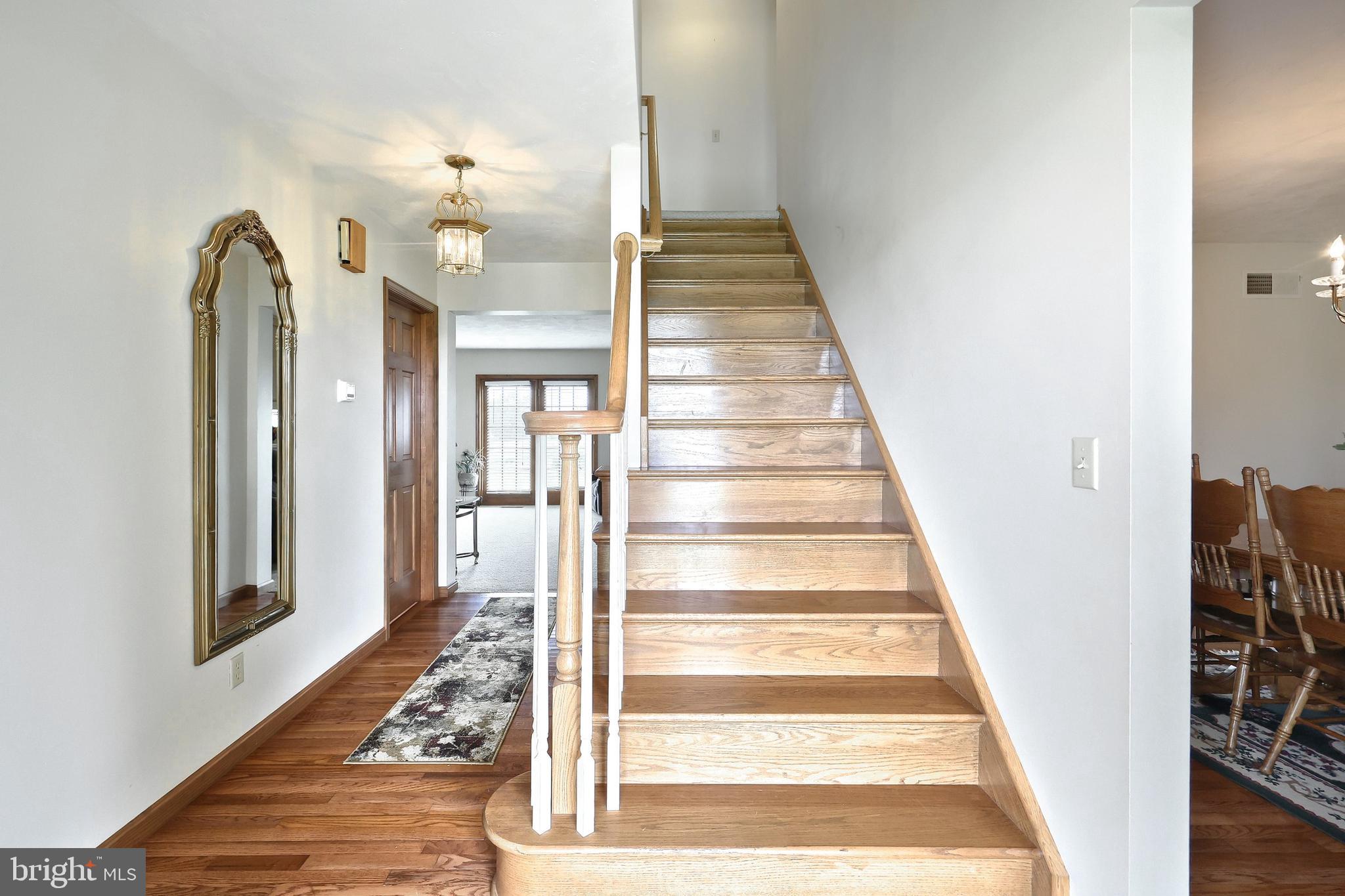 574 Mathias Road Littlestown, PA 17340 - Photo 27 of 65 a view of a hallway with wooden floor and staircase
