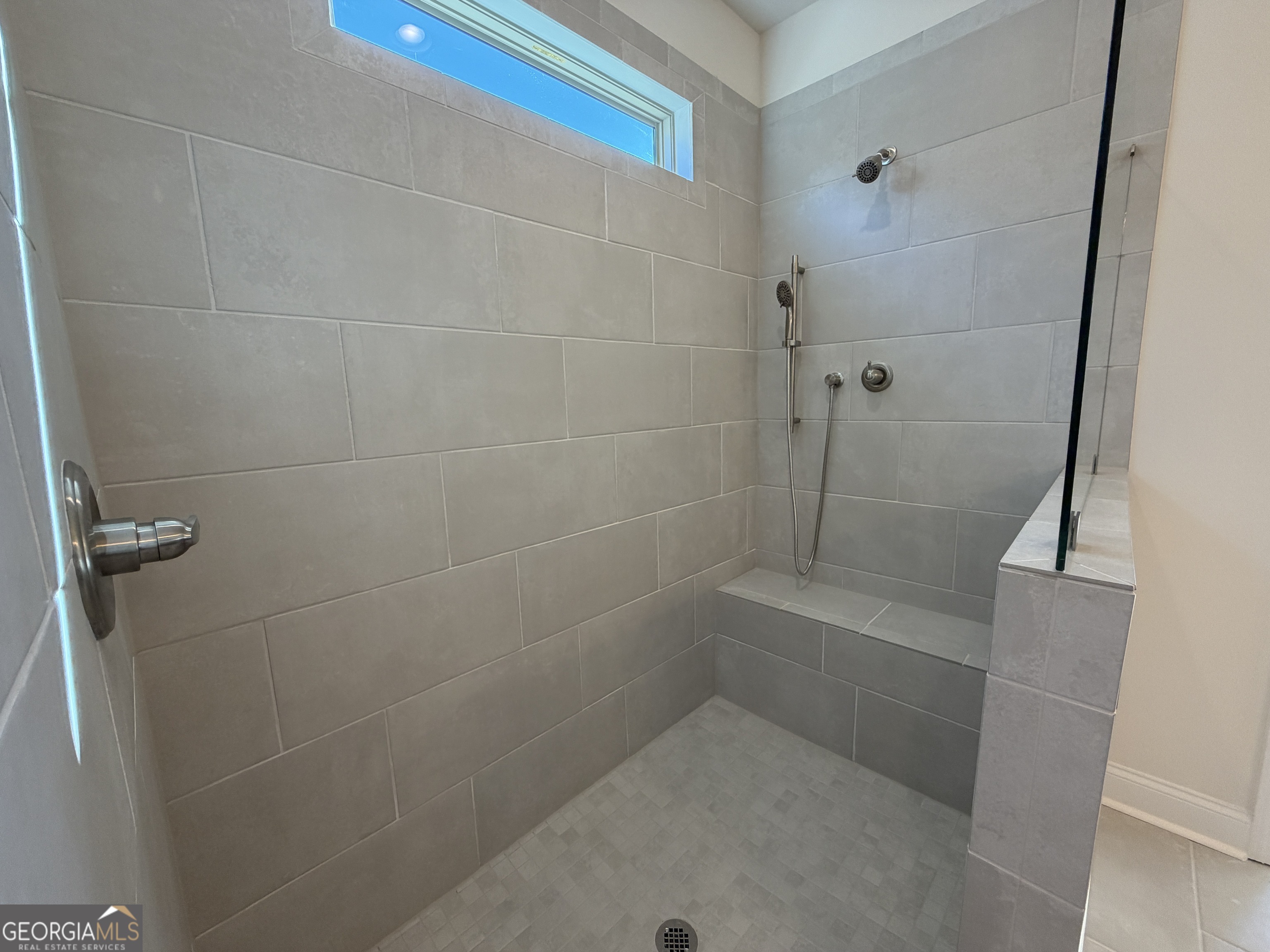 233 Oakdale Road, Unit 53 Jefferson, GA 30549 - Photo 28 of 64 Bench, Hand held, shower head, shampoo niche, transom window above,