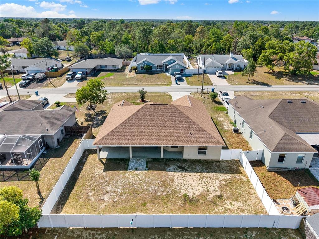 4400 Dior Road Spring Hill, FL 34609 - Photo 35 of 37 a view of yard with swimming pool and outdoor seating