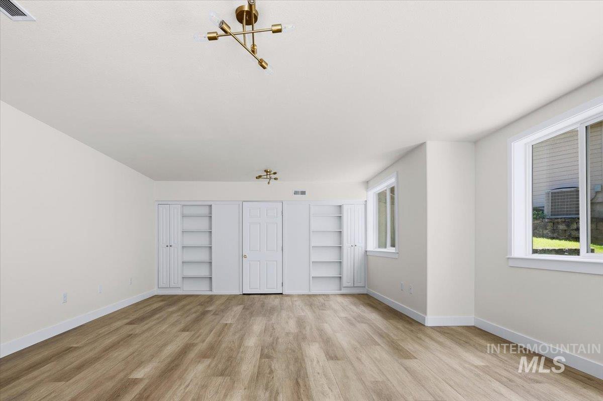 725 North Eagle Road Eagle, ID 83616 - Photo 25 of 45 Spacious interior room featuring wood-finish flooring, recessed lighting, and bright white walls