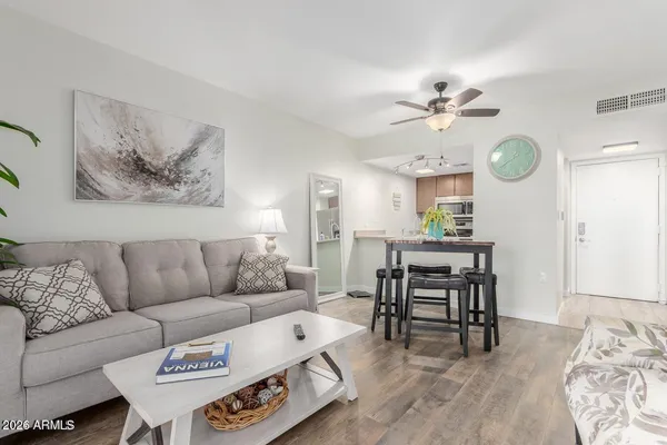 a living room with furniture and wooden floor