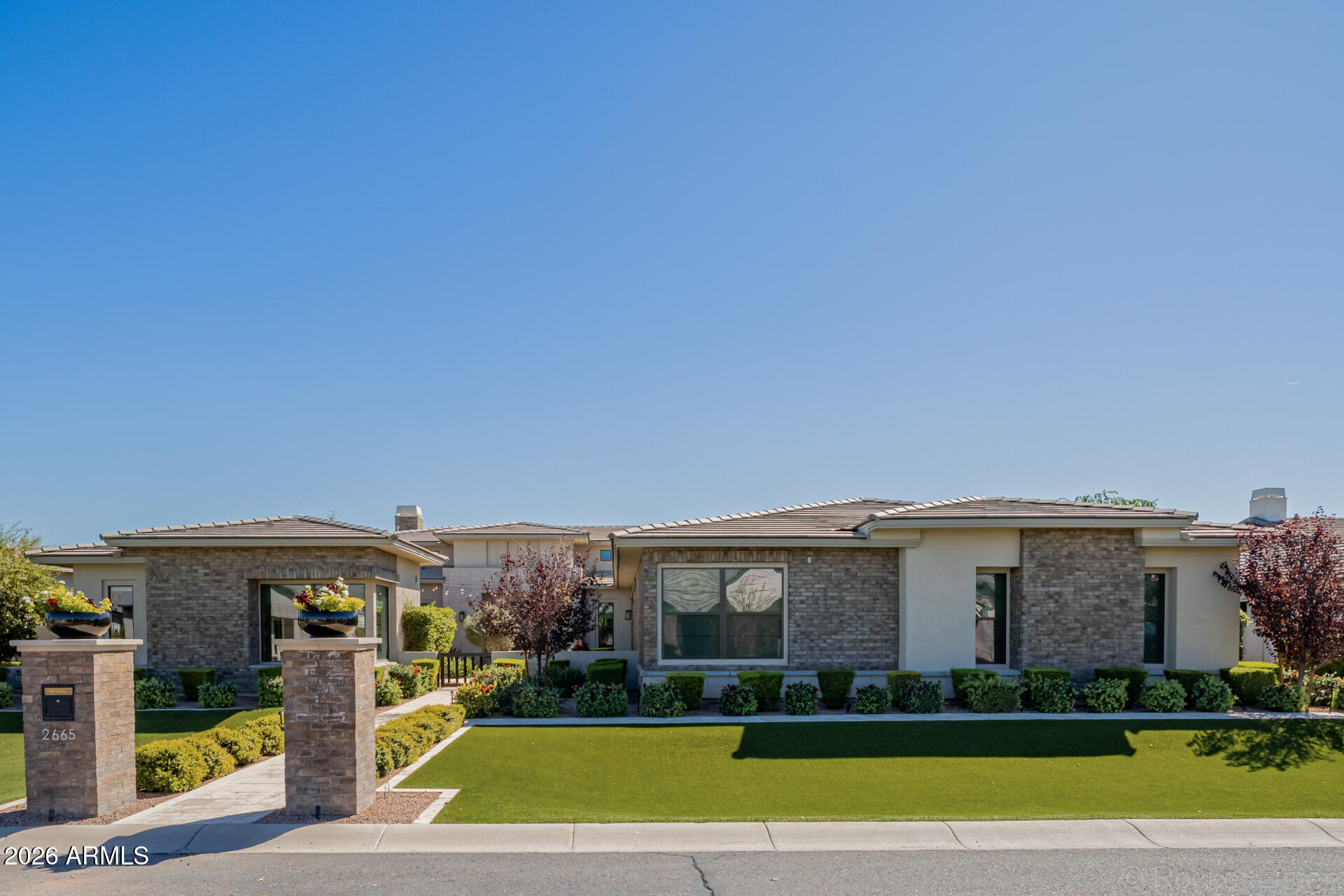 2665 East Hummingbird Way Gilbert, AZ 85297 - Photo 97 of 100 a view of a big house with a big yard and large trees