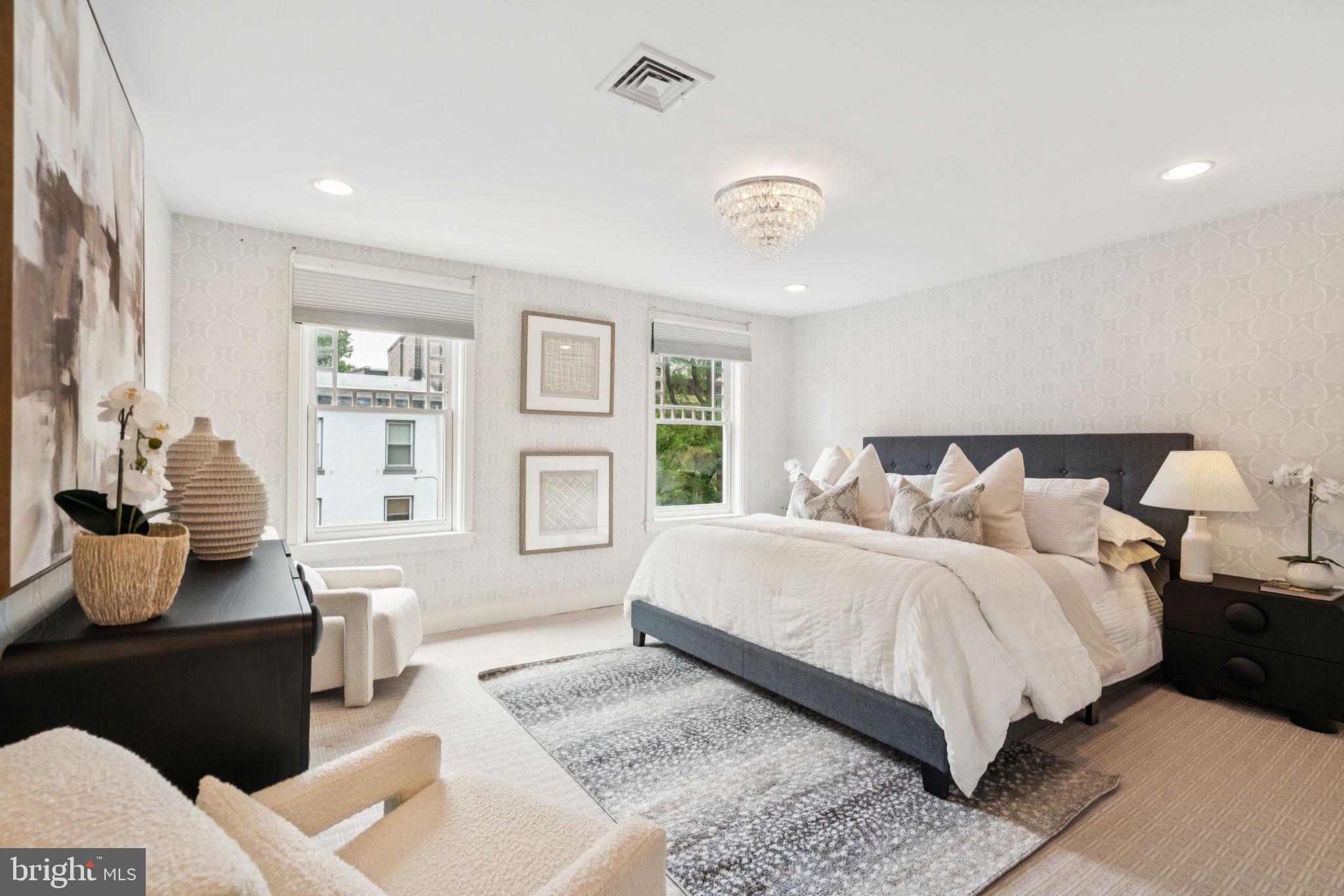 2109 Locust Street Philadelphia, PA 19103 - Photo 15 of 38 a spacious bedroom with a bed and wooden floor