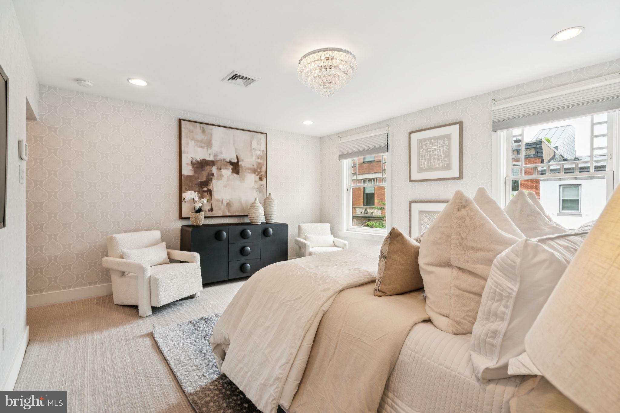 2109 Locust Street Philadelphia, PA 19103 - Photo 16 of 38 a bedroom with a large bed and a couch