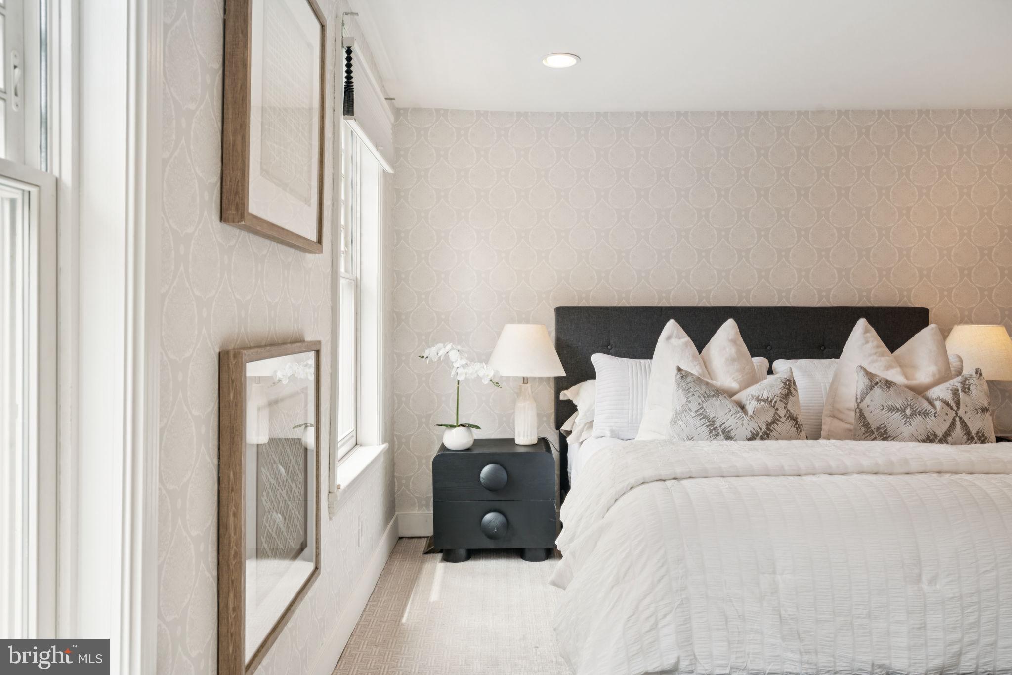 2109 Locust Street Philadelphia, PA 19103 - Photo 17 of 38 a large bed sitting in a bedroom next to a window