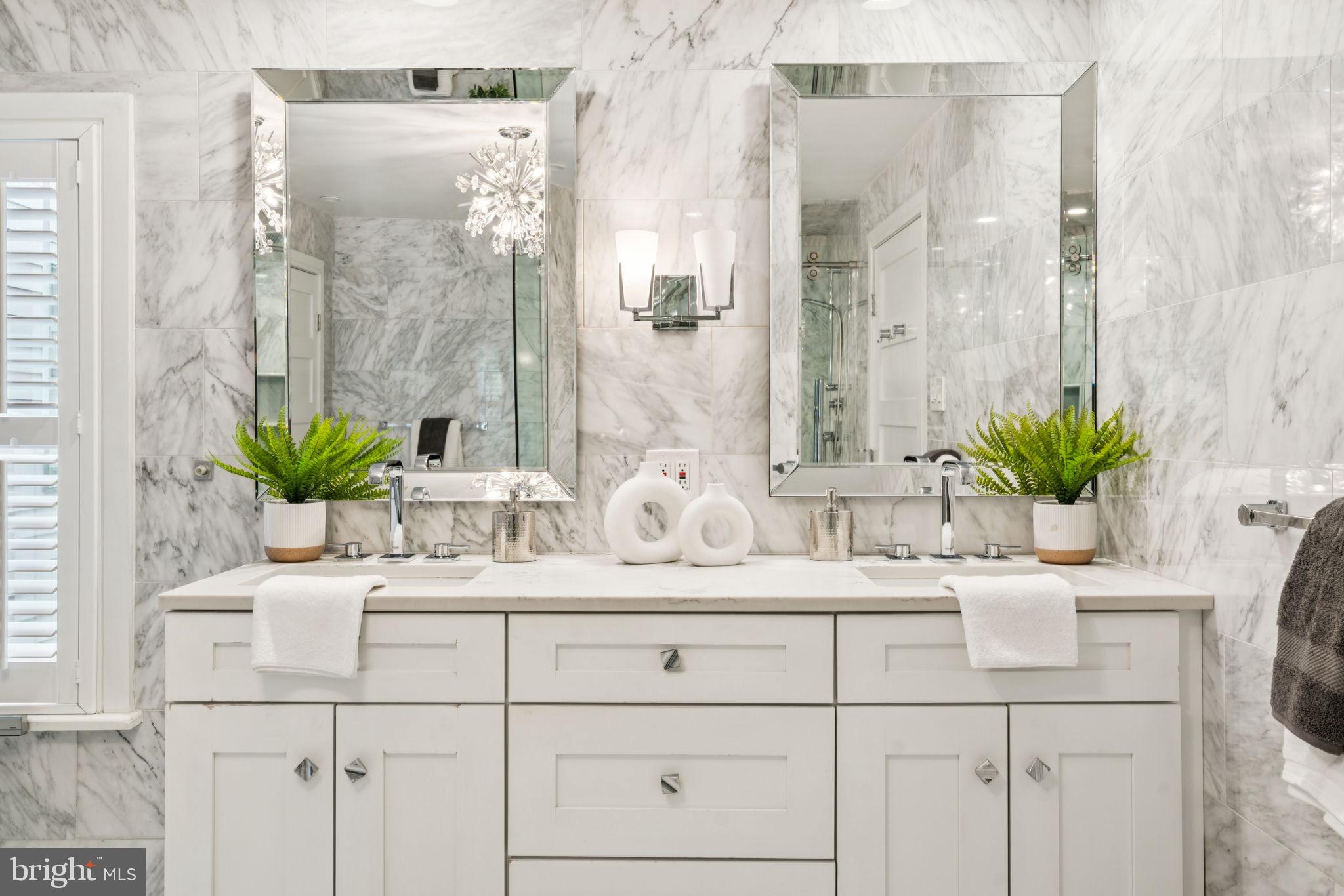 2109 Locust Street Philadelphia, PA 19103 - Photo 18 of 38 a bathroom with a sink a potted plant and a mirror