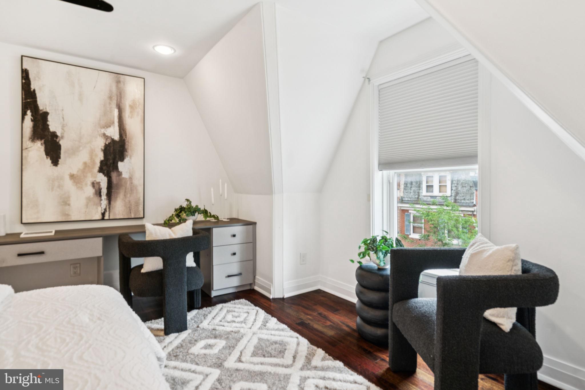 2109 Locust Street Philadelphia, PA 19103 - Photo 27 of 38 a bedroom with a bed and wooden floor