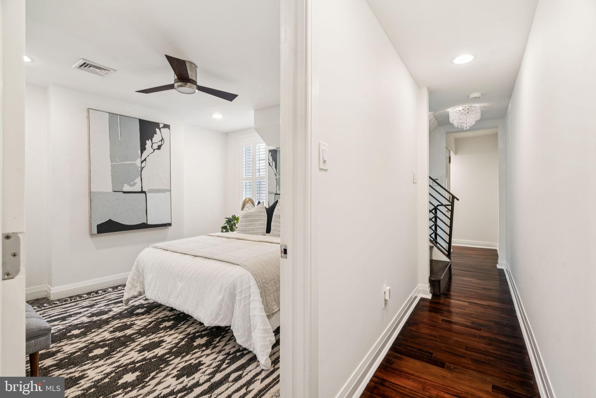2109 Locust Street Philadelphia, PA 19103 - Photo 29 of 38 a bedroom with a large bed and a chandelier