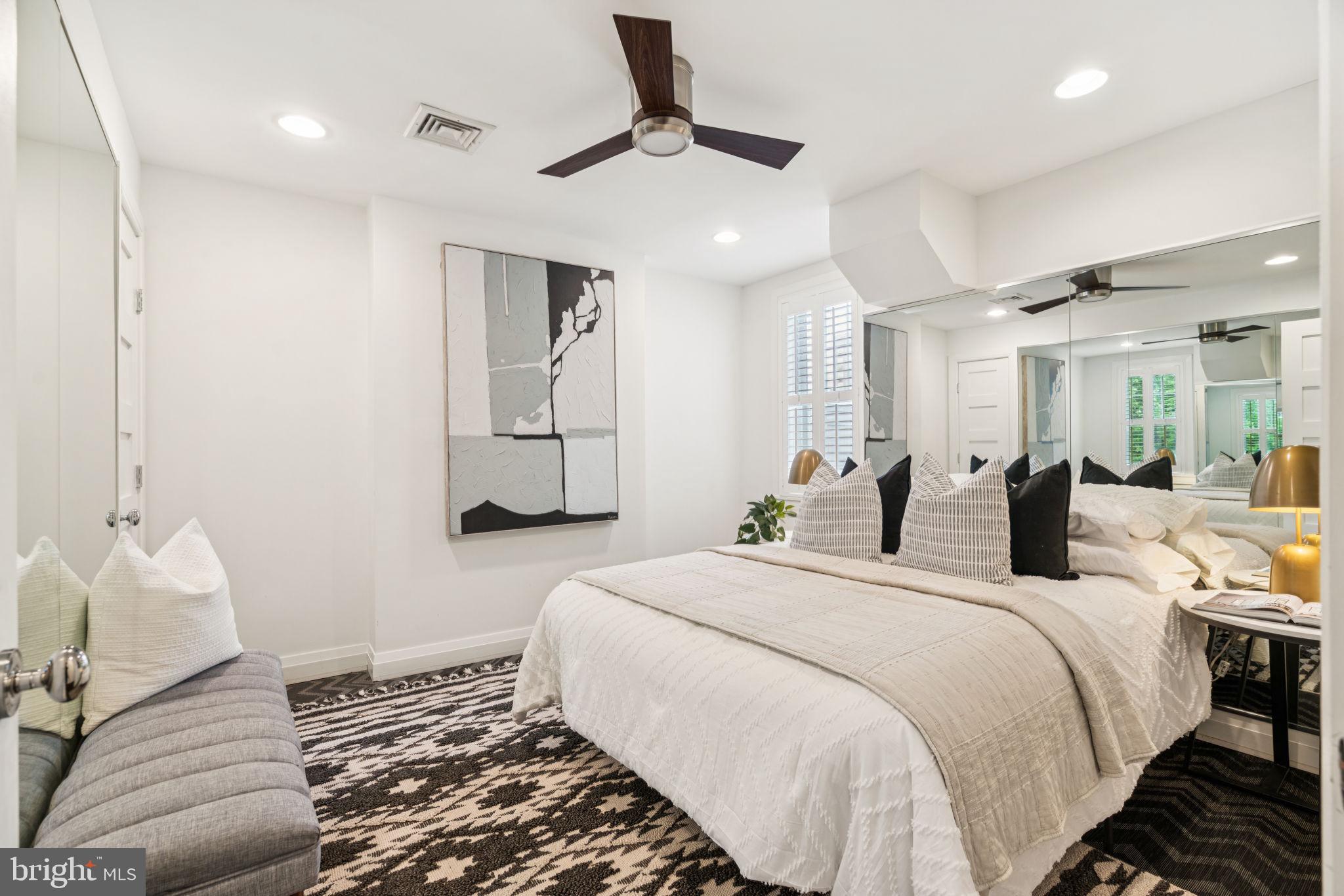 2109 Locust Street Philadelphia, PA 19103 - Photo 30 of 38 a bedroom with a bed and a chandelier