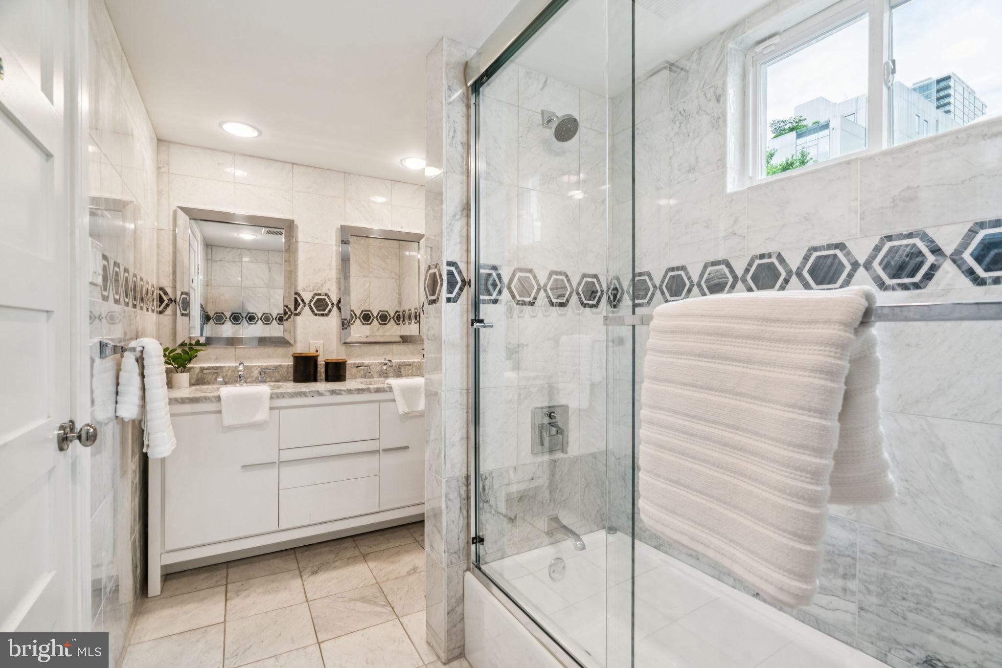 2109 Locust Street Philadelphia, PA 19103 - Photo 33 of 38 a bathroom with a shower sink and mirror