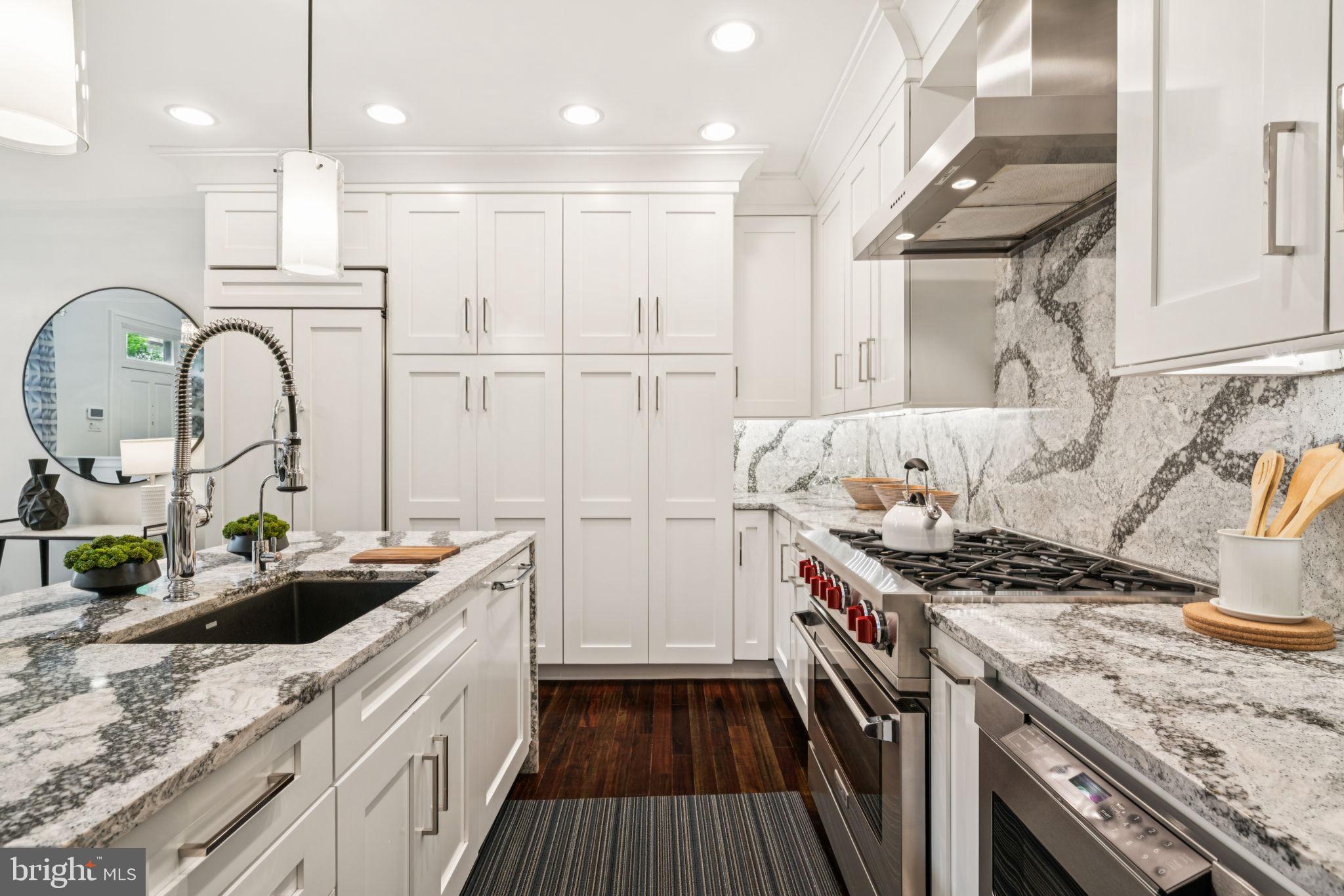 2109 Locust Street Philadelphia, PA 19103 - Photo 5 of 38 a kitchen with granite countertop a sink stove and cabinets