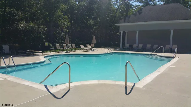 a view of swimming pool with chairs