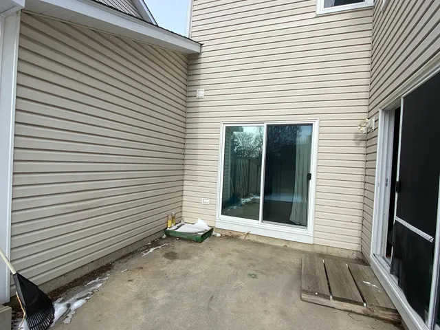 a view of a room with a door and a large window