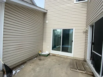 a view of backyard with wooden fence and trees