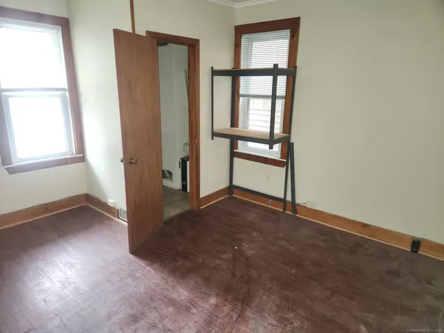 an empty room with windows and closet