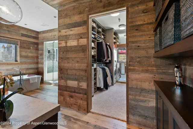 a bedroom with a large bed and a flat tv screen on dresser