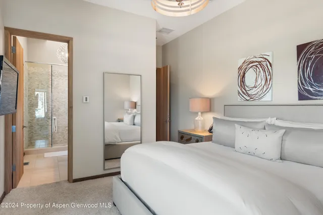 a bathroom with a granite countertop sink a mirror and shower