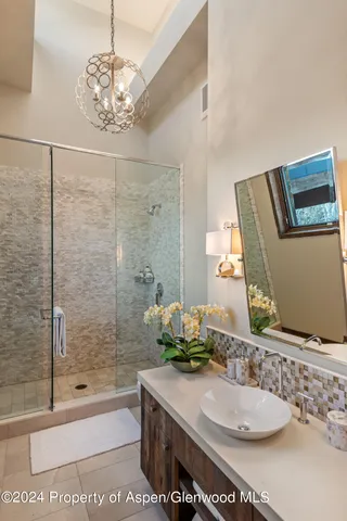 a bedroom with a bed couch and a window