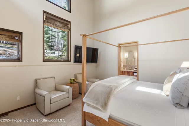 a bathroom with a granite countertop sink a toilet and a mirror
