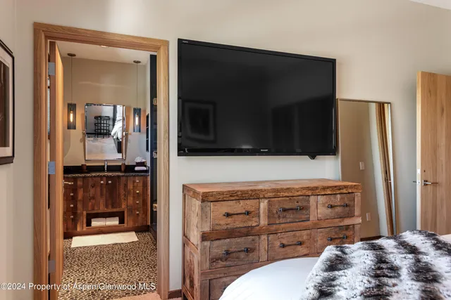 a bathroom with a granite countertop shower a sink and mirror