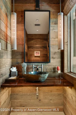 a view of a room with wooden walls and stairs