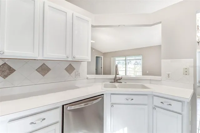 a kitchen with stainless steel appliances granite countertop a refrigerator a stove and a sink with cabinets