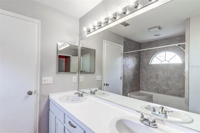 a bathroom with a bathtub and a sink
