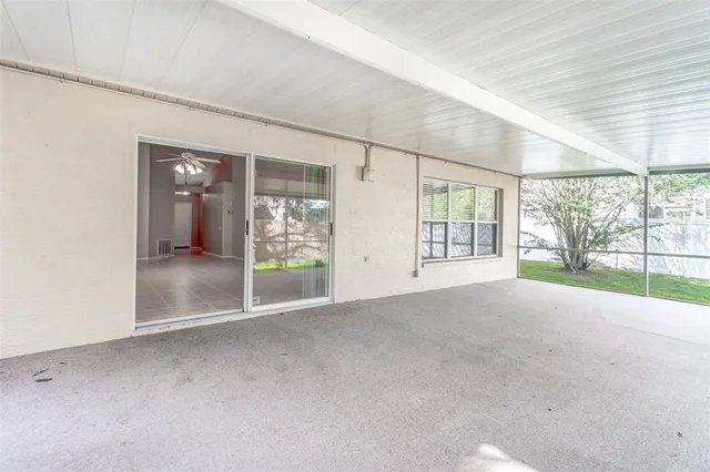 a view of a house with backyard and a tree