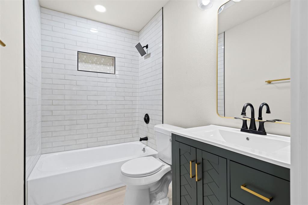 1300 East Baltimore Avenue Fort Worth, TX 76104 - Photo 12 of 25 a bathroom with a sink a toilet and shower