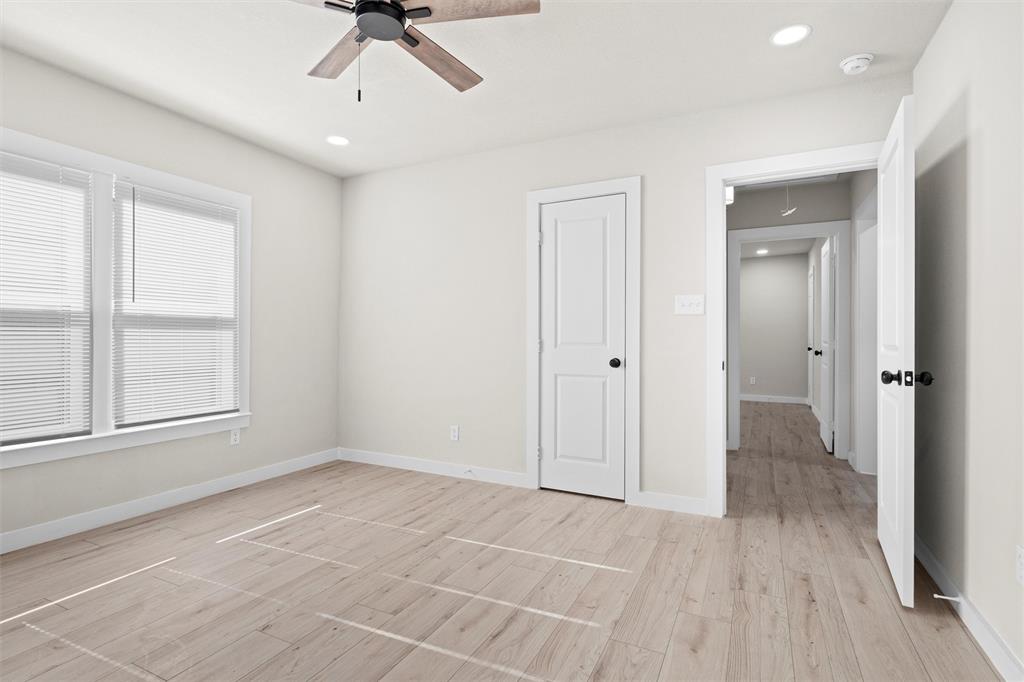1300 East Baltimore Avenue Fort Worth, TX 76104 - Photo 14 of 25 a view of an empty room with a window and wooden floor