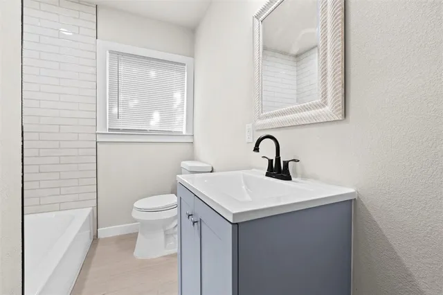 a bathroom with a sink a toilet and a bathtub