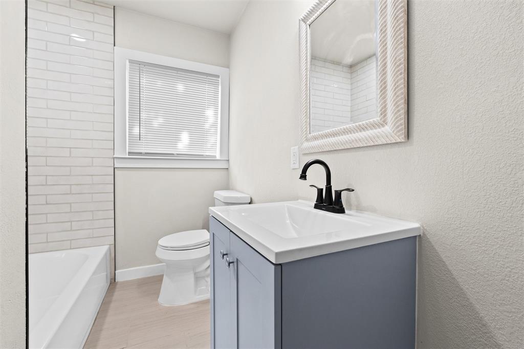 1300 East Baltimore Avenue Fort Worth, TX 76104 - Photo 16 of 25 a bathroom with a sink a toilet and a bathtub