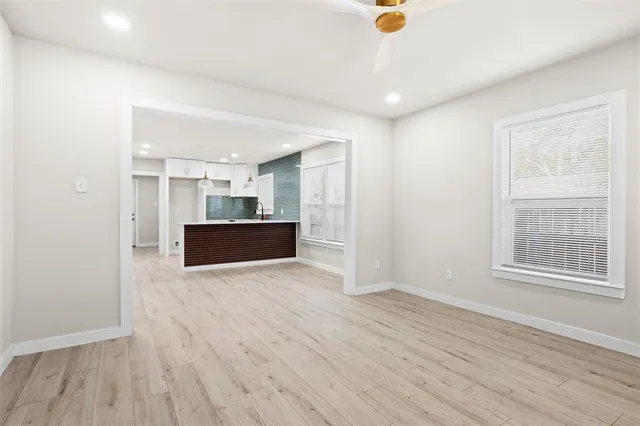 a view of kitchen and hall with wooden floor