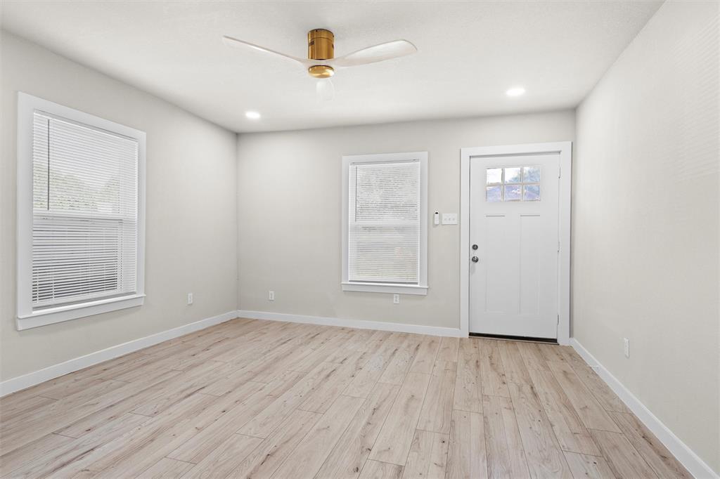 1300 East Baltimore Avenue Fort Worth, TX 76104 - Photo 5 of 25 wooden floor in an empty room with a window