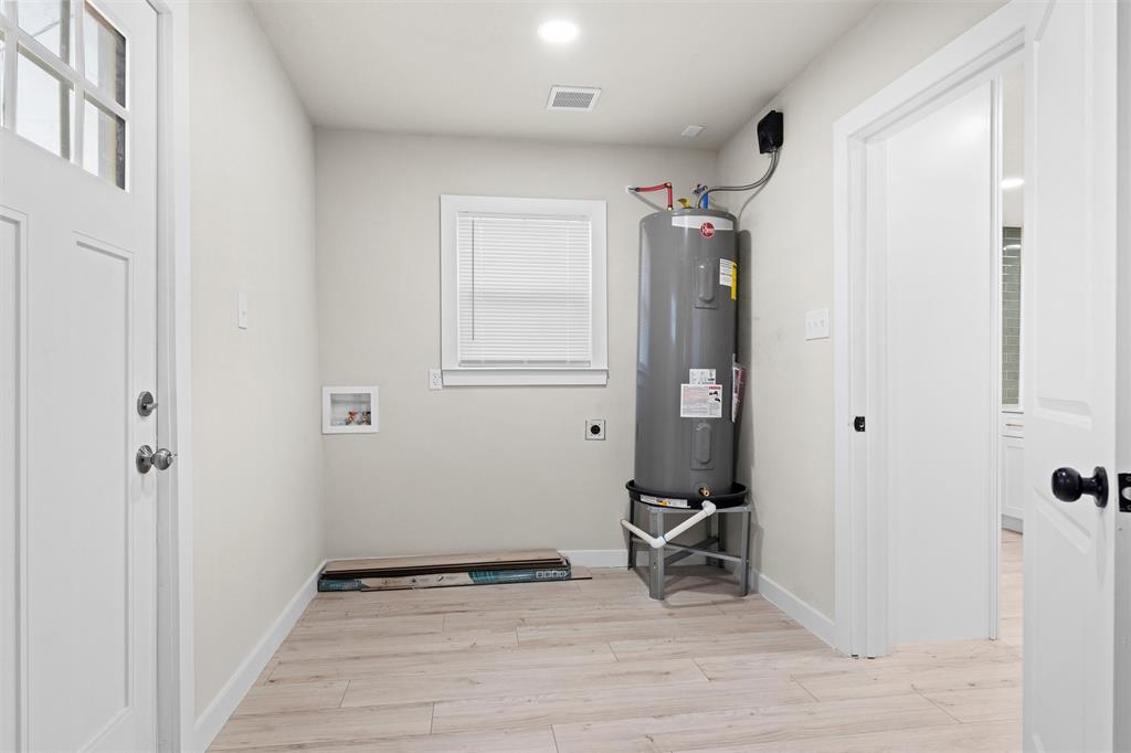 1300 East Baltimore Avenue Fort Worth, TX 76104 - Photo 9 of 25 a view of a room with wooden floor and bathroom