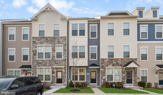 a front view of a residential apartment building with a yard