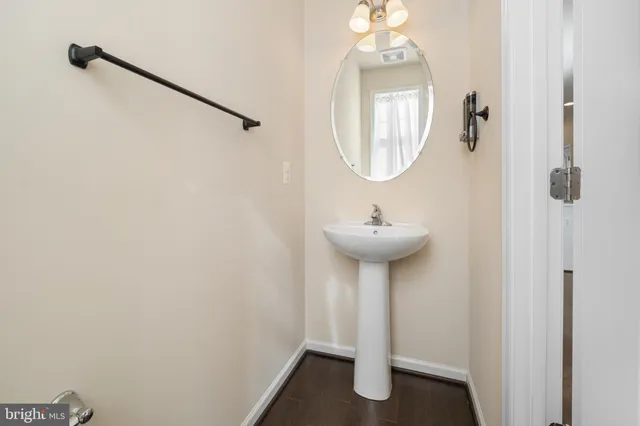 a view of a kitchen with a sink and a refrigerator