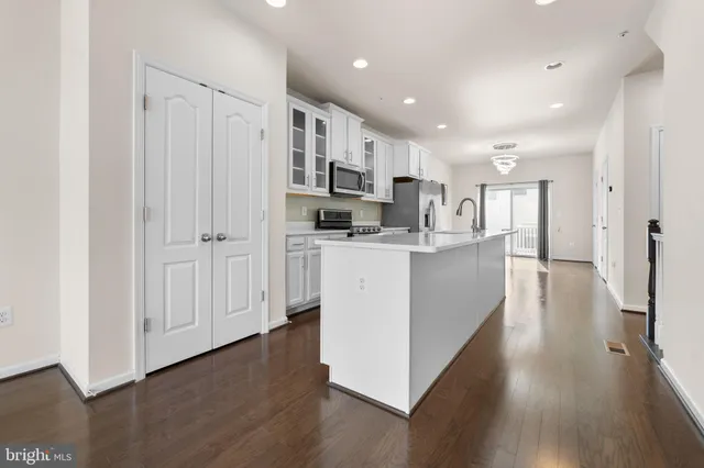 a kitchen with stainless steel appliances a sink stove and refrigerator