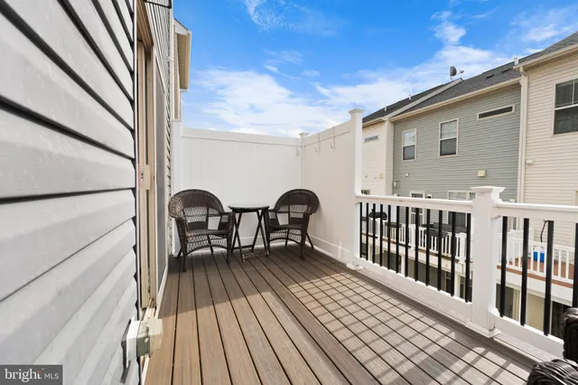 a view of a living room a refrigerator and windows