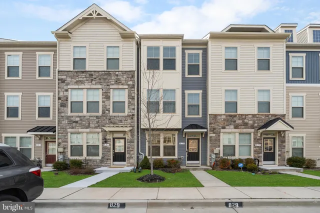 a front view of a residential apartment building with a yard