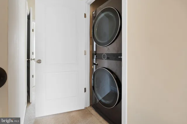 an empty room with closet and a ceiling fan