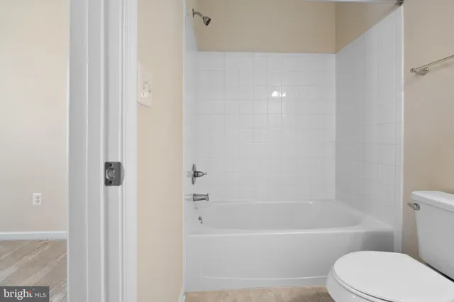 a front view of a house with a yard and fountain