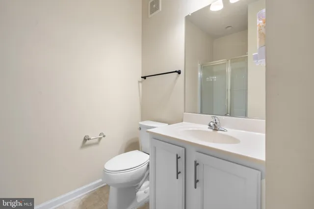 a bathroom with a sink a toilet and vanity